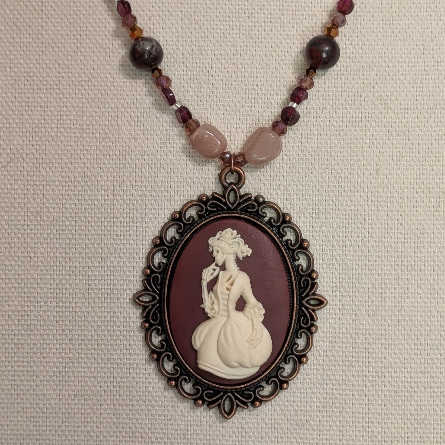 ✨Mauvelight Intrigue✨| Rhodolite Garnet, Sunstone & Tourmaline-in-Jasper Necklace With Skeletal Cameo & Floral Toggle